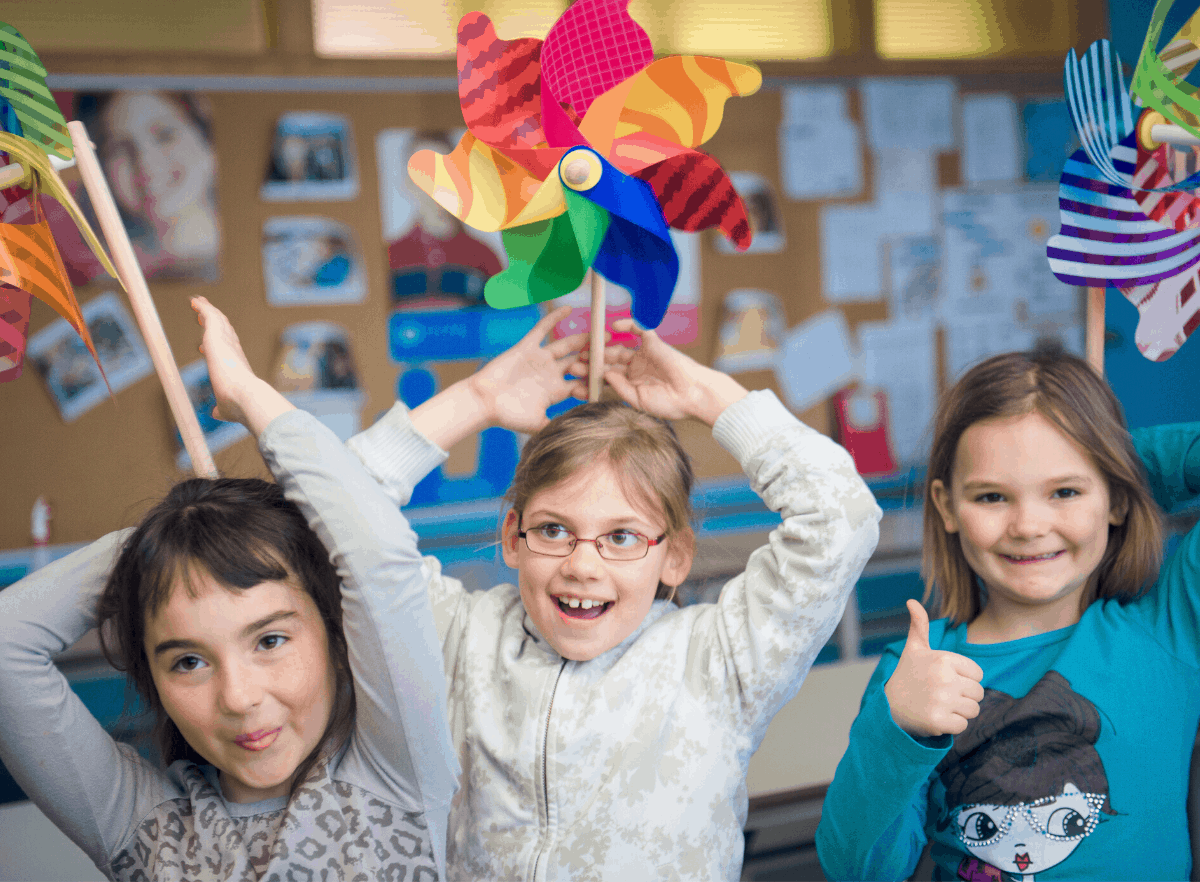 children with pinwheels on their heads