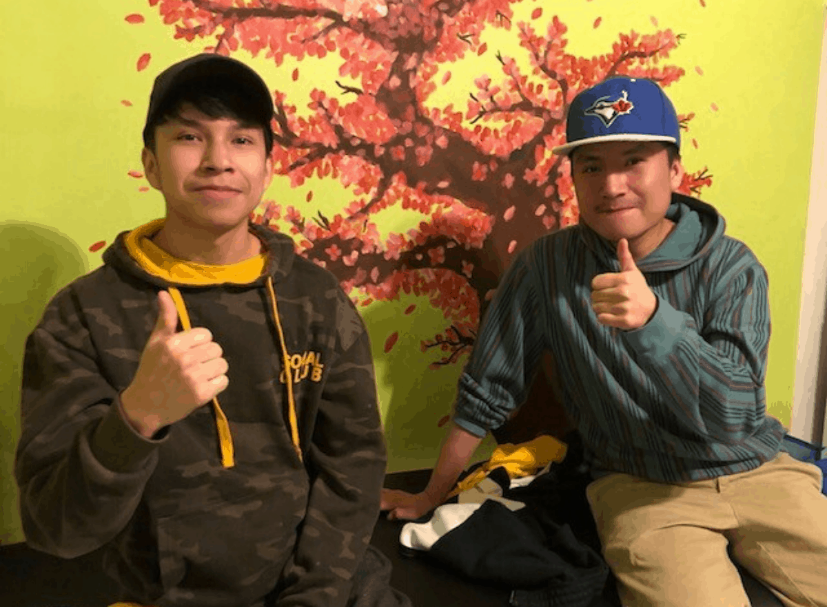 Two teens giving a thumbs up