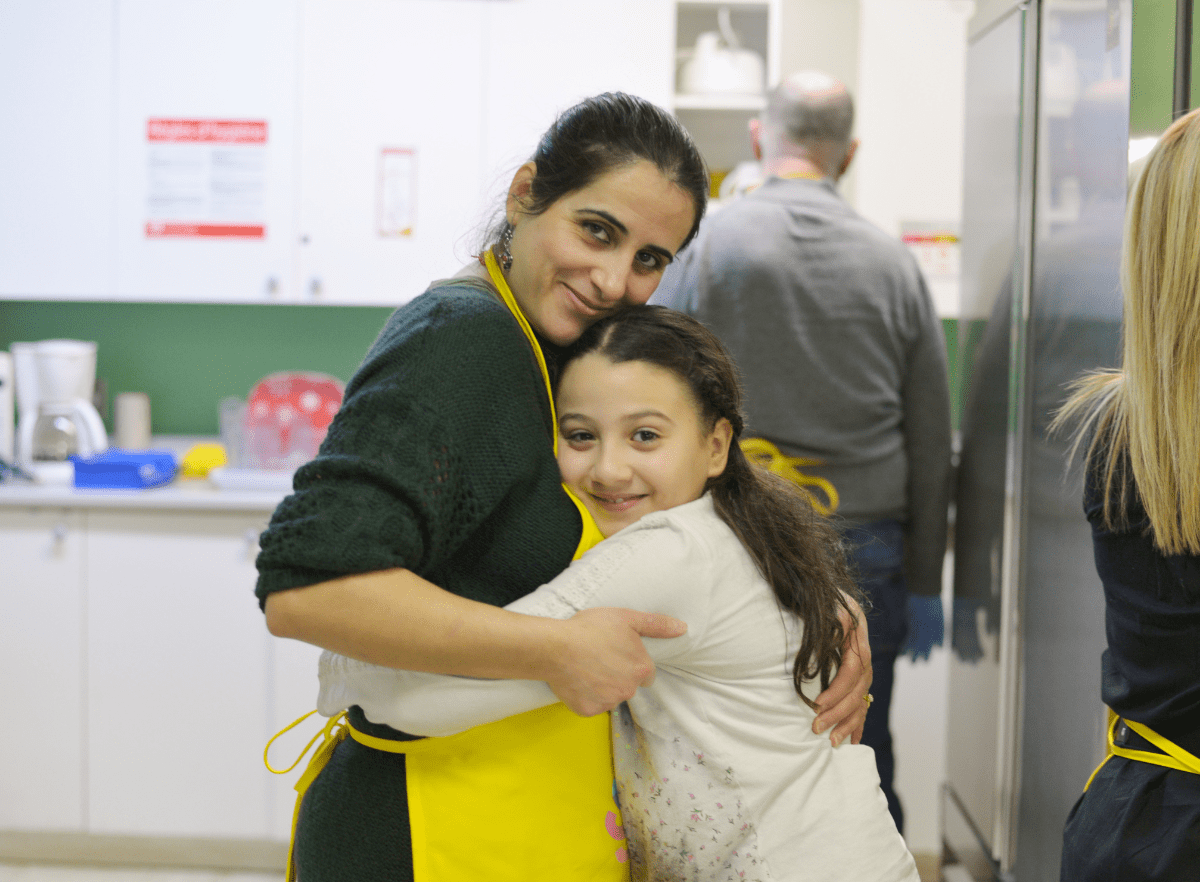 volunteer and student hug
